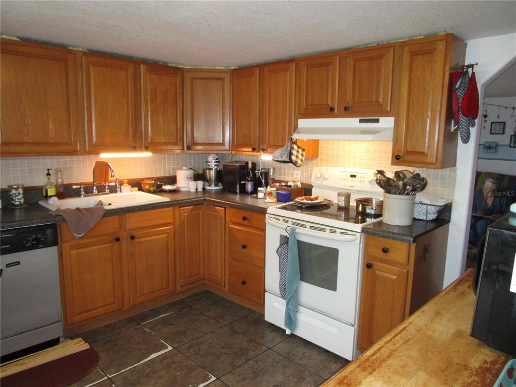 17609 Bathurst Avenue Spring Hill, FL 34610 - Photo 5 of 60 a kitchen with a sink stove and cabinets