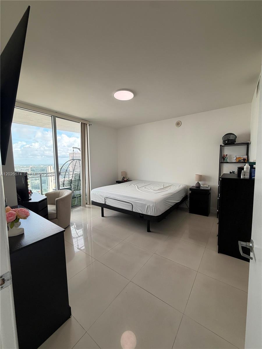 90 Southwest 3rd Street, Unit 4006 Miami, FL 33130 - Photo 6 of 19 a bedroom with furniture and window