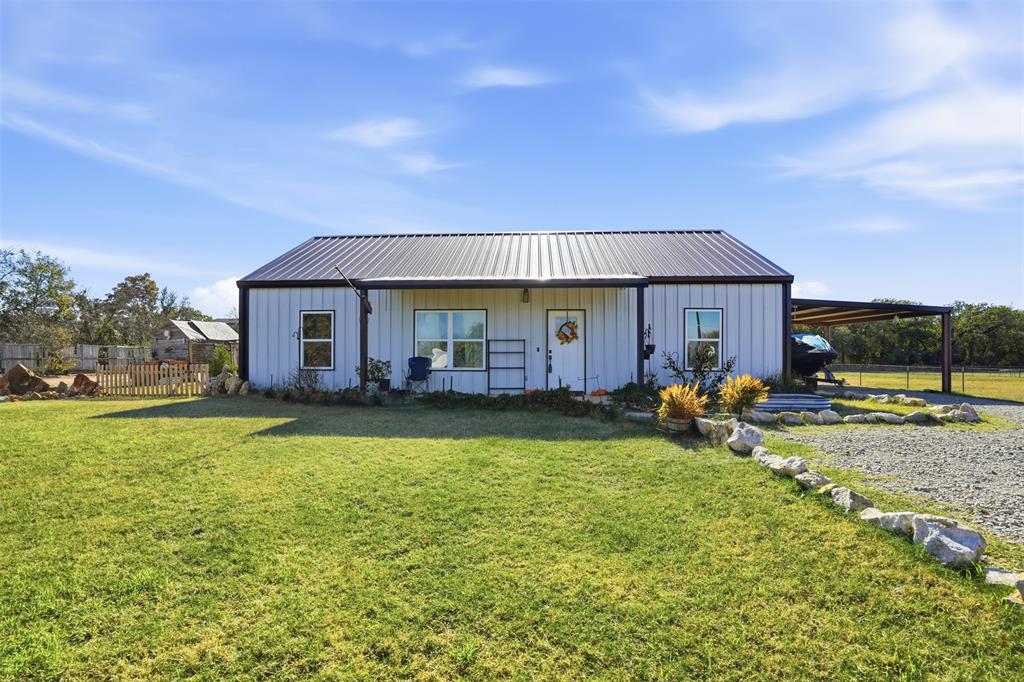 a view of a house with backyard porch and sitting area