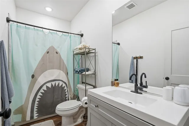 a bathroom with a granite countertop sink a mirror a glass door and shower