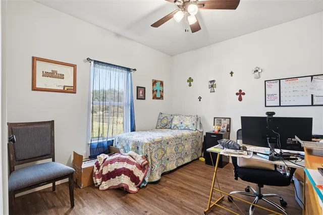 a bedroom with furniture and a book shelf