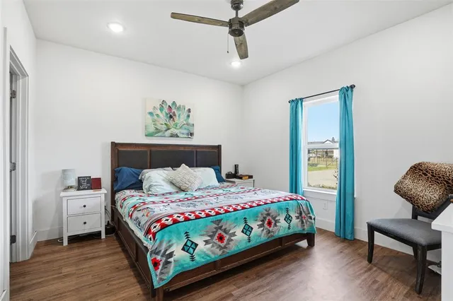 a bedroom with a bed table and a chair