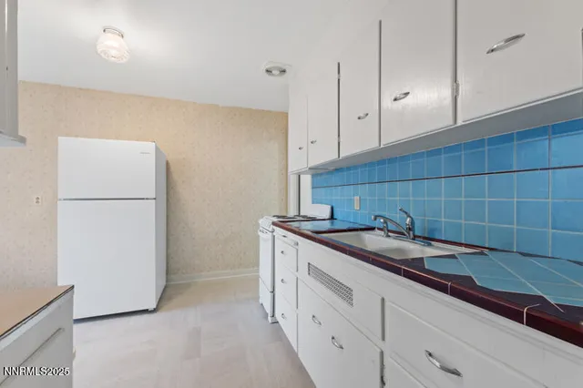 a kitchen with a sink and a refrigerator