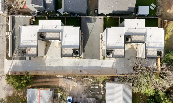 an aerial view of residential houses with outdoor space