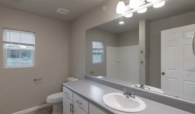 an empty room with closet and windows