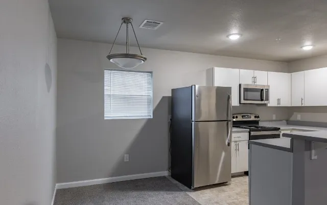 a view of a kitchen with a sink and cabinets
