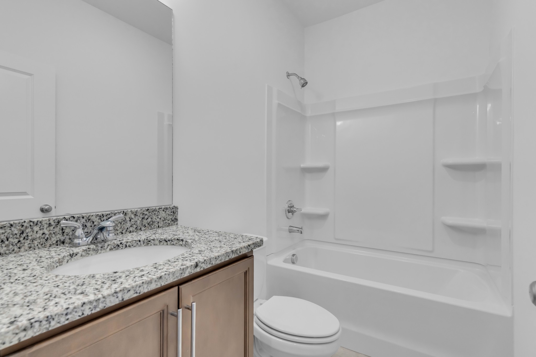 945 Brooklyn Xing Road Gallatin, TN 37066 - Photo 13 of 15 a bathroom with a granite countertop sink a toilet and bathtub