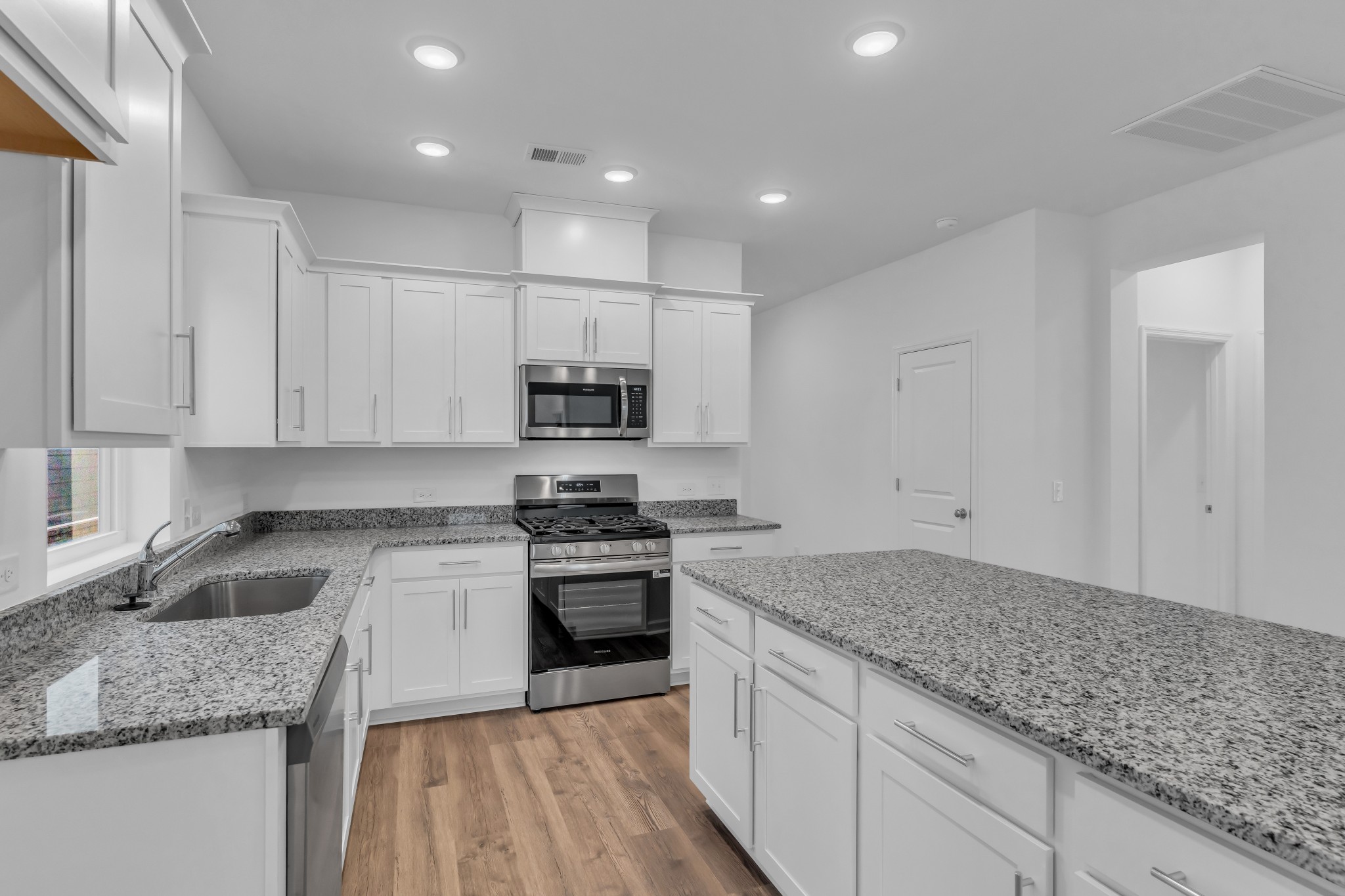 945 Brooklyn Xing Road Gallatin, TN 37066 - Photo 7 of 15 a kitchen with stainless steel appliances granite countertop a sink stove and cabinets