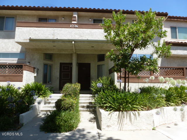 1736 Sinaloa Road, Unit 321 Simi Valley, CA 93065 - Photo 1 of 26 a front view of a house with garden