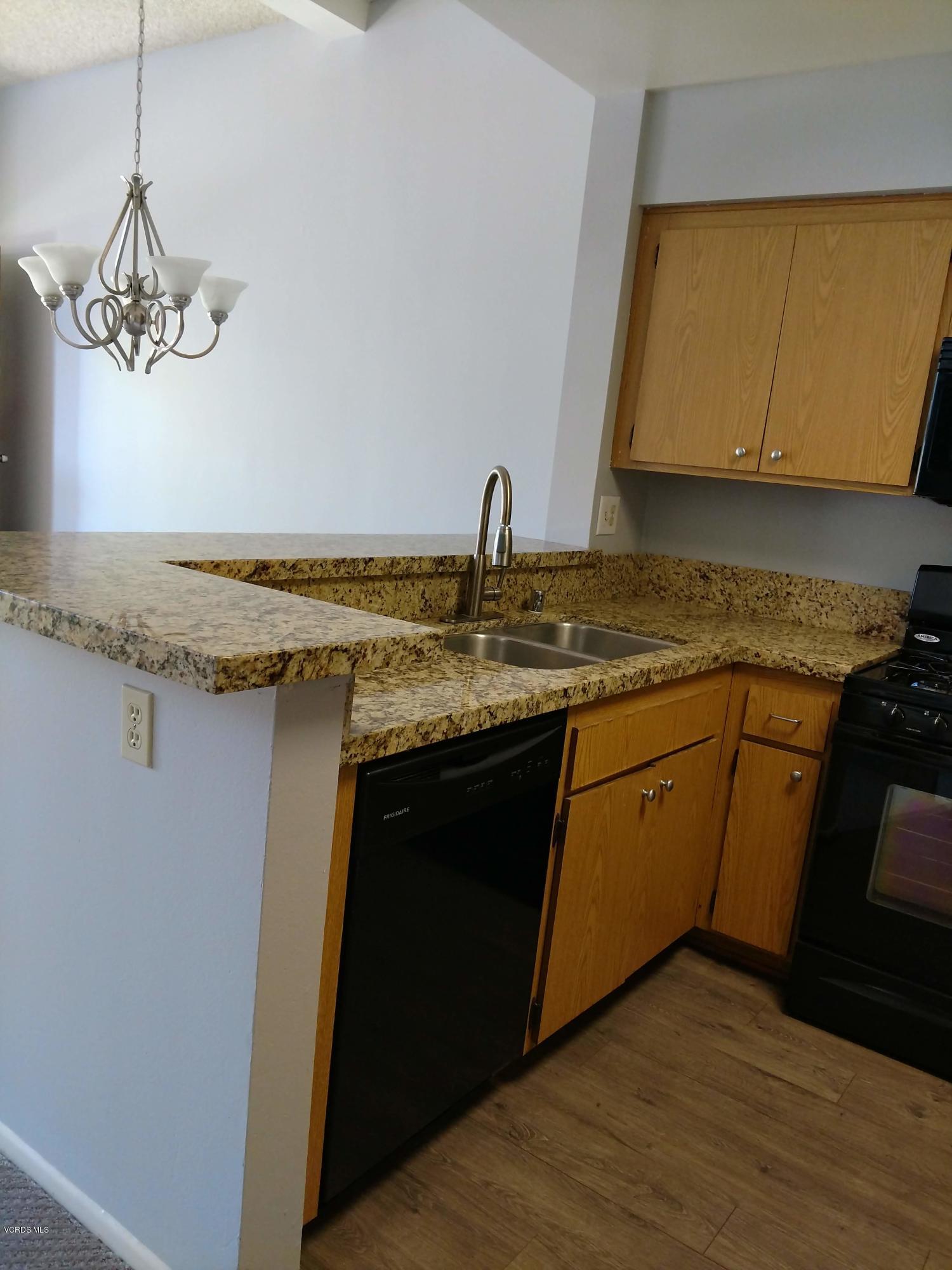 1736 Sinaloa Road, Unit 321 Simi Valley, CA 93065 - Photo 11 of 26 a kitchen with a sink a stove and cabinets