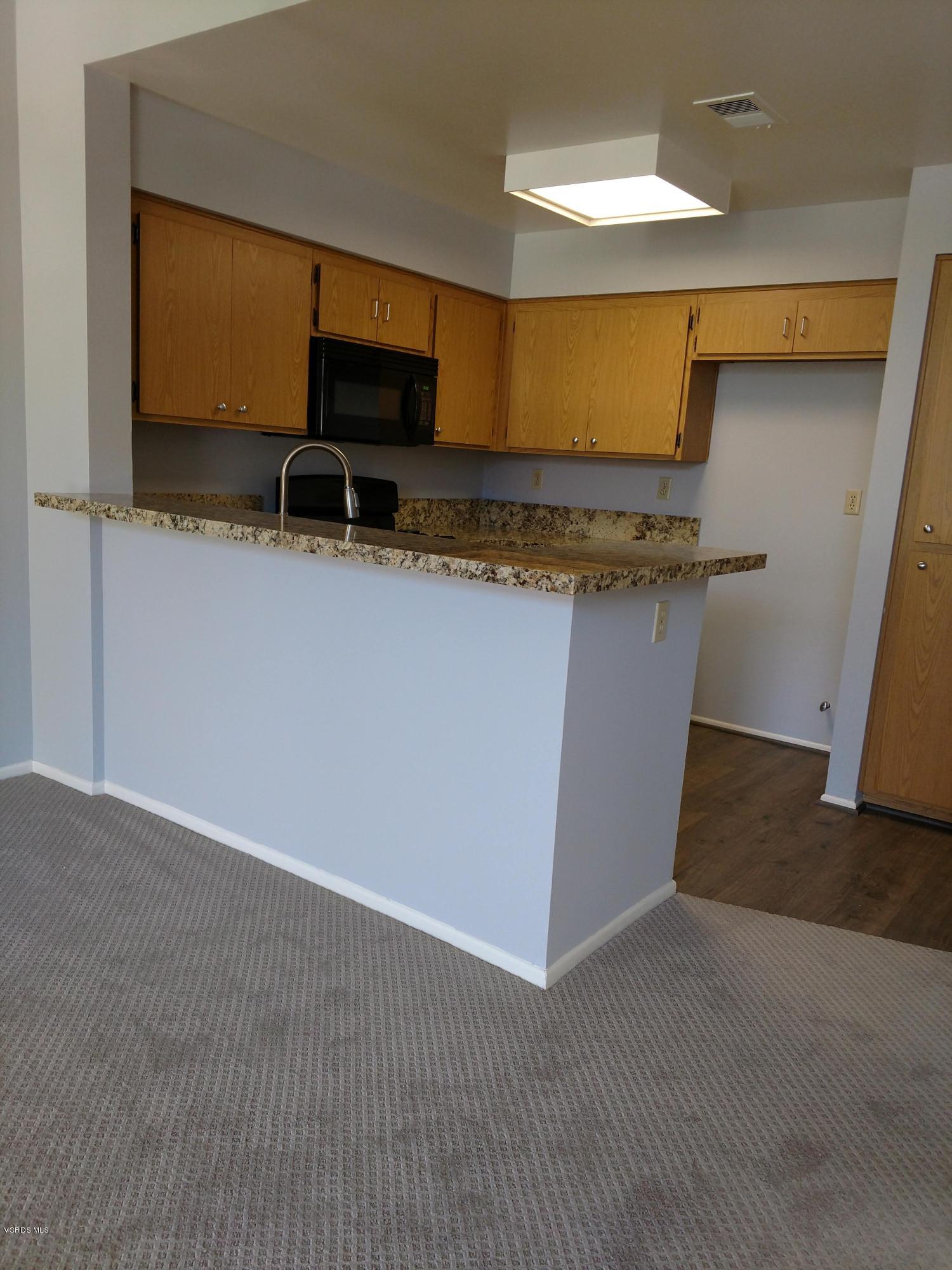 1736 Sinaloa Road, Unit 321 Simi Valley, CA 93065 - Photo 9 of 26 a view of room with wooden floor and chair