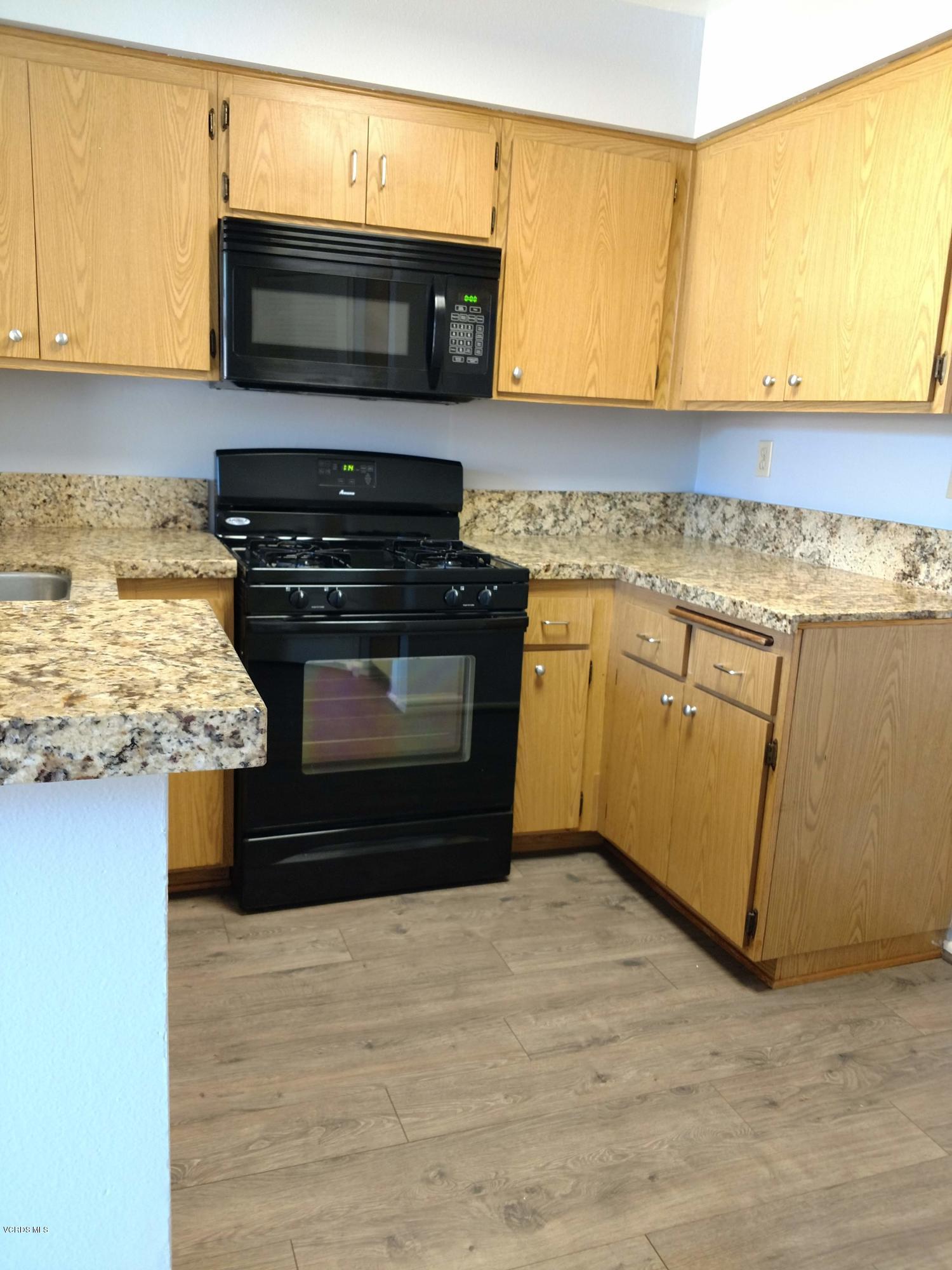 1736 Sinaloa Road, Unit 321 Simi Valley, CA 93065 - Photo 10 of 26 a kitchen with a stove and a microwave