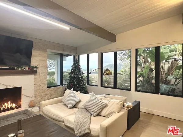 a kitchen with a table chairs refrigerator and cabinets