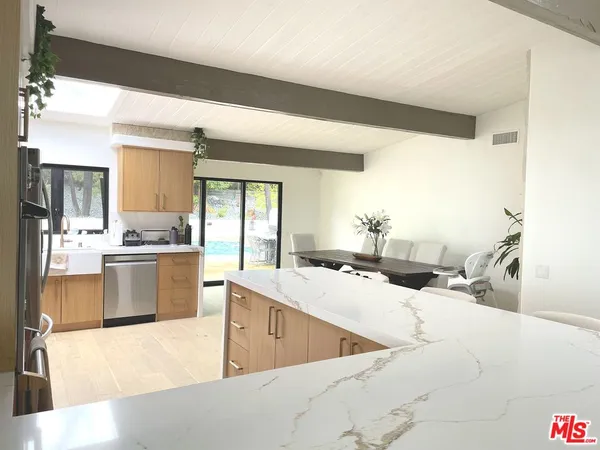 a bedroom with a large bed and a flat screen tv