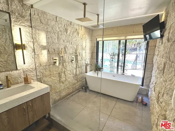 a bathroom with a sink mirror vanity and toilet