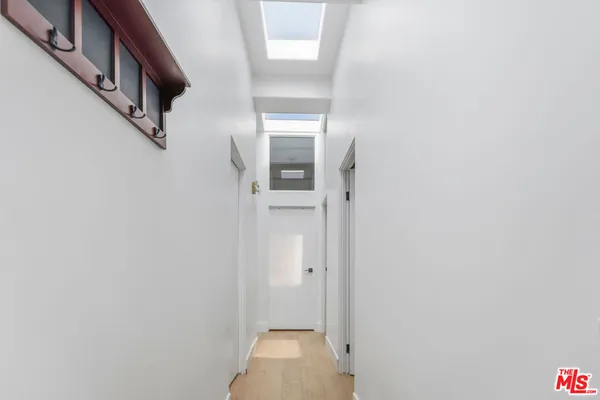 a bed sitting in a bedroom next to a window with lamp