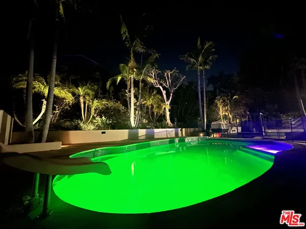 a view of a swimming pool with an outdoor space and seating area