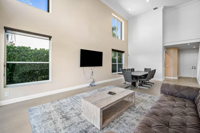 a view of a livingroom with a ceiling fan and window