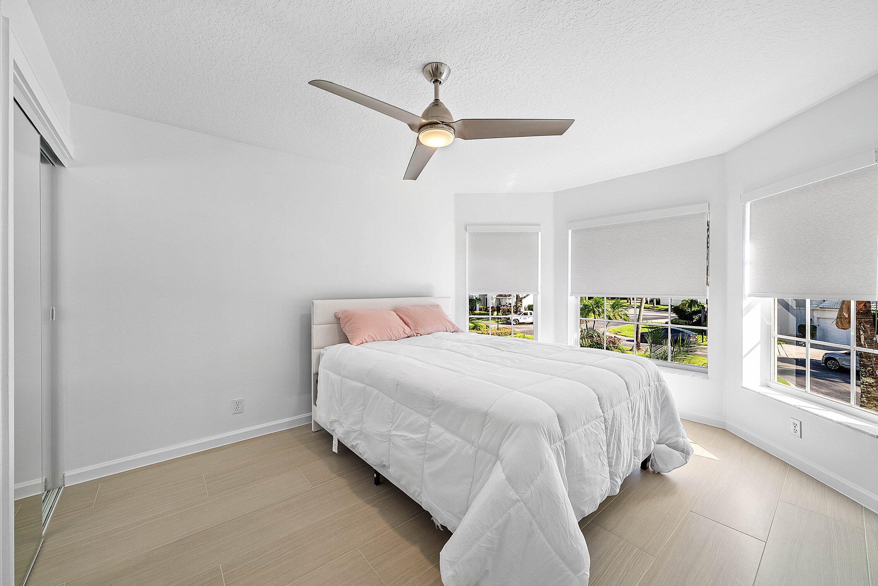 5855 Northwest 42nd Way Boca Raton, FL 33496 - Photo 28 of 77 a bedroom with a bed a dresser and a book shelf