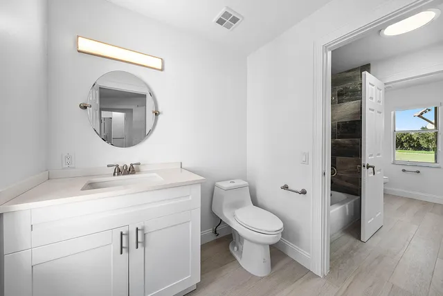 a front view of a house with a garden and plants