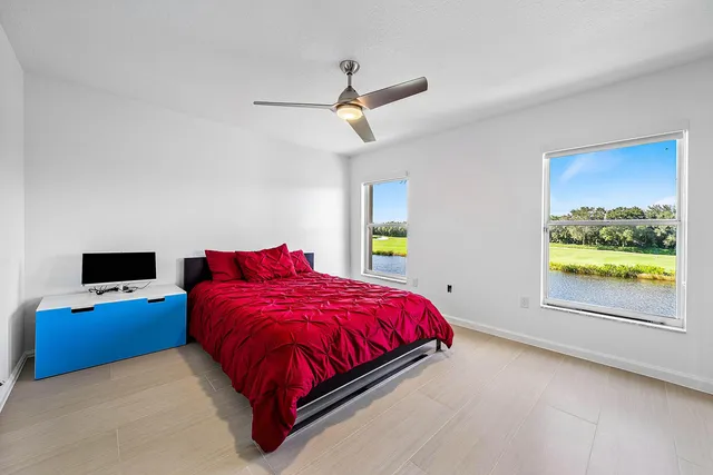 a front view of a house with a garden and plants