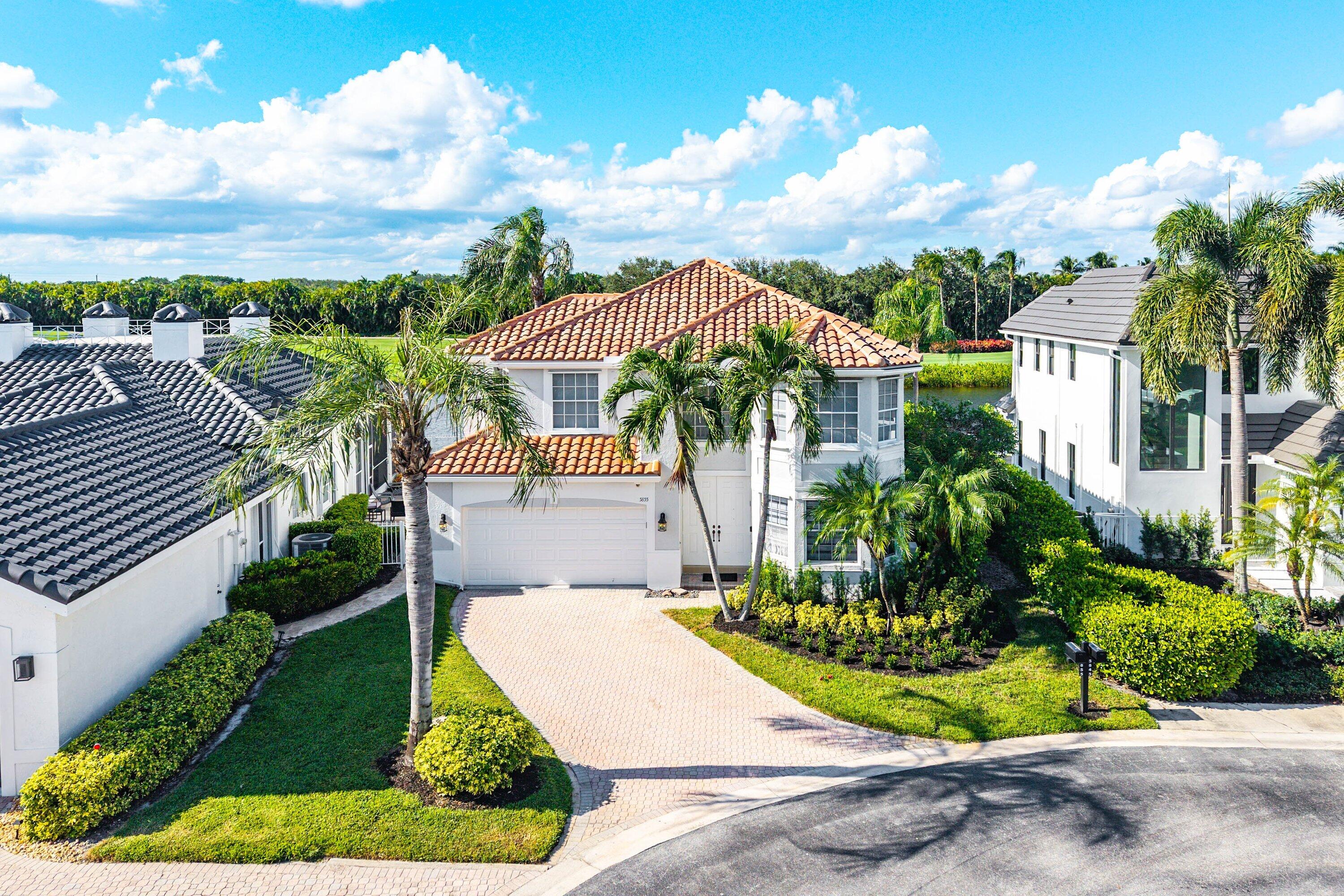 5855 Northwest 42nd Way Boca Raton, FL 33496 - Photo 46 of 77 a front view of a house with a yard and outdoor seating