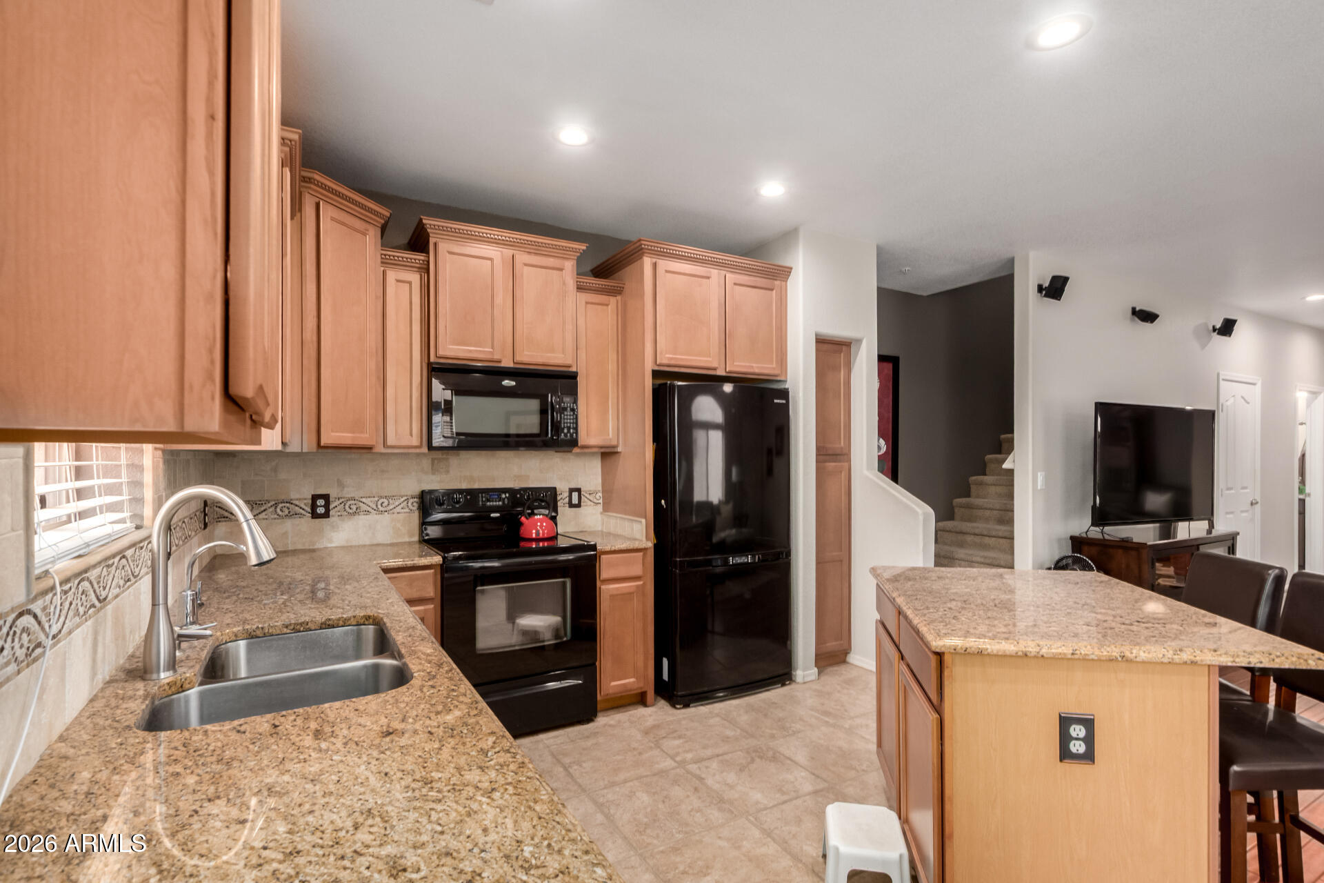 280 South Evergreen Road, Unit 1350 Tempe, AZ 85288 - Photo 17 of 62 a kitchen with granite countertop a refrigerator stove and sink