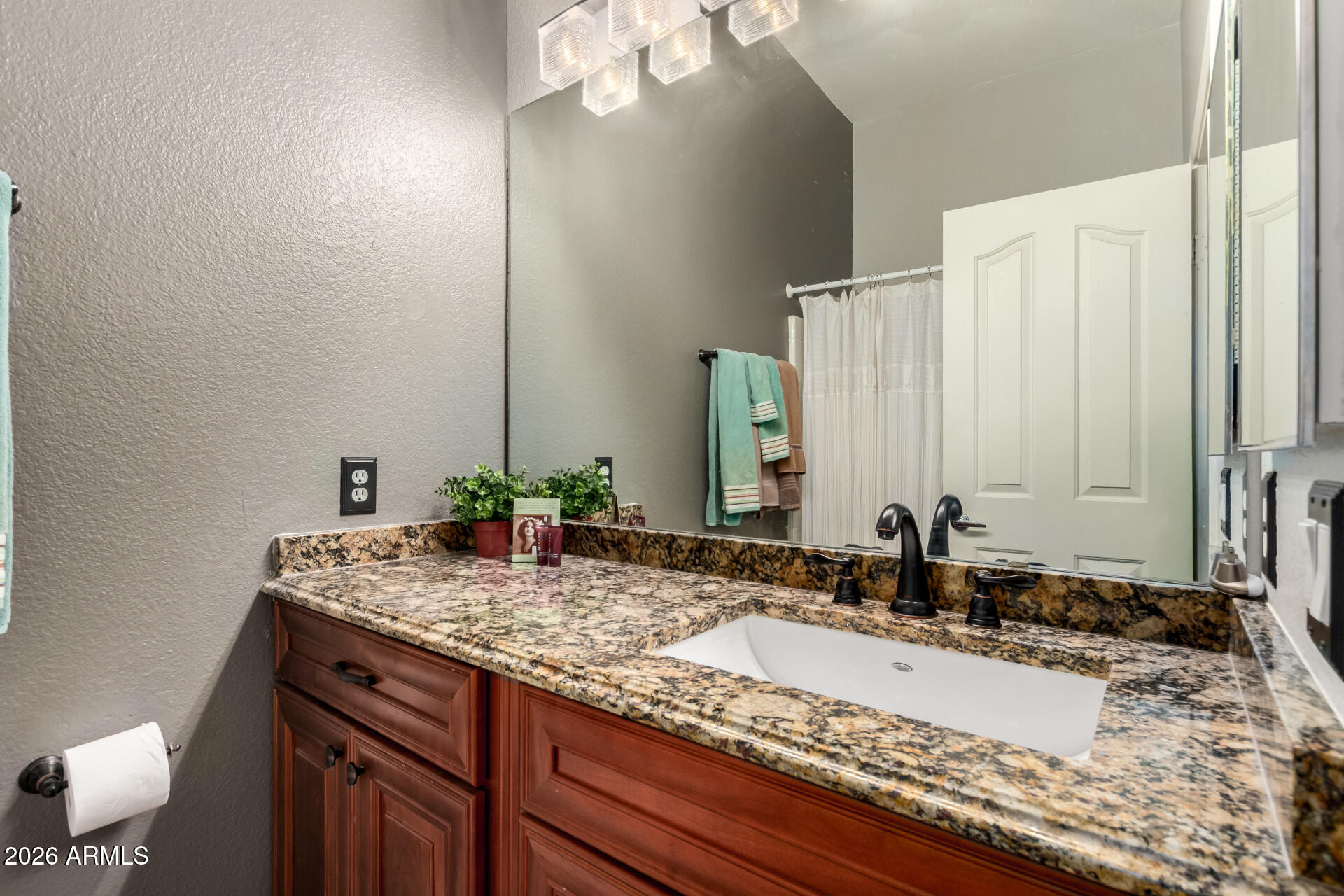 280 South Evergreen Road, Unit 1350 Tempe, AZ 85288 - Photo 18 of 62 a bathroom with a granite countertop sink and a mirror