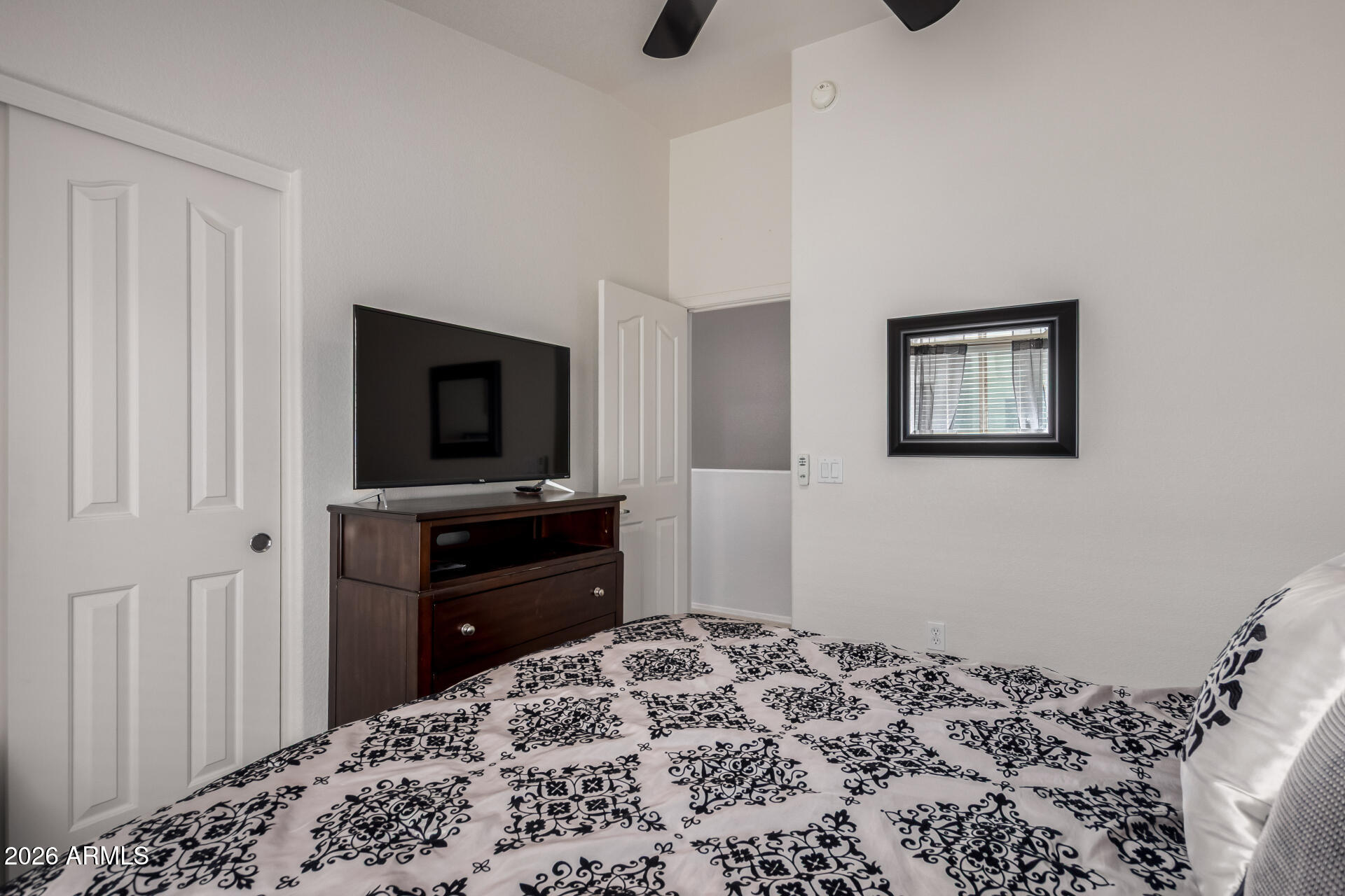 280 South Evergreen Road, Unit 1350 Tempe, AZ 85288 - Photo 26 of 62 a bedroom with a bed and a flat screen tv