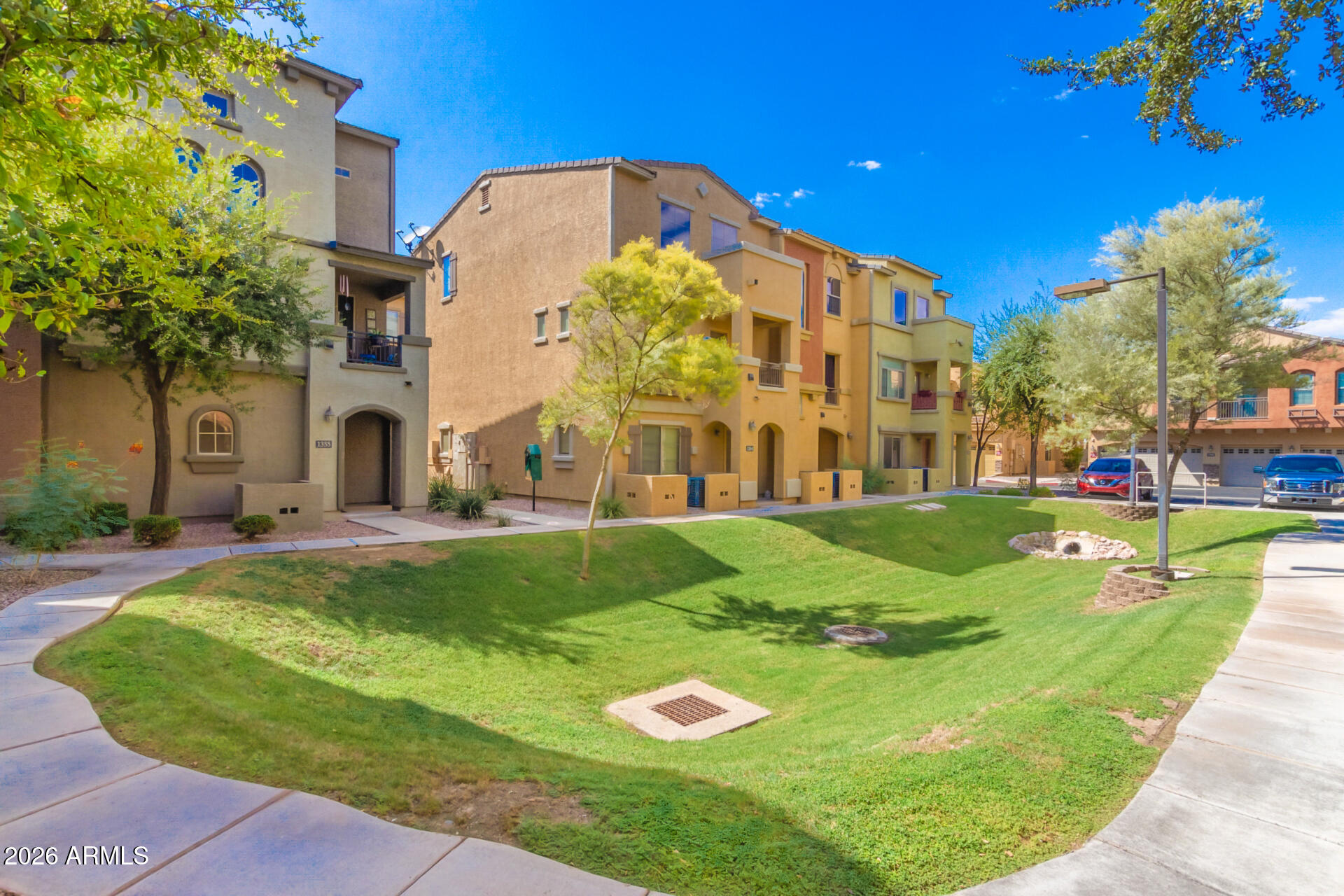 280 South Evergreen Road, Unit 1350 Tempe, AZ 85288 - Photo 53 of 62 a view of a big building with a big yard and plants