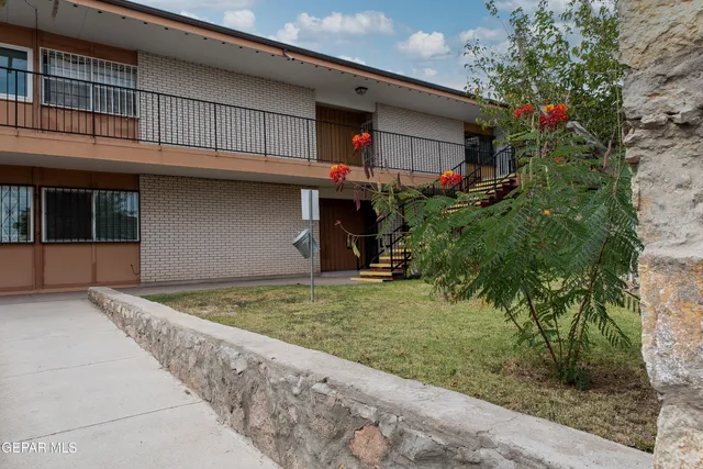 a backyard of a house with lots of green space and fountain