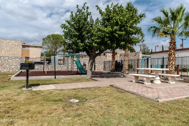 a view of a terrace with glass top table and chairs