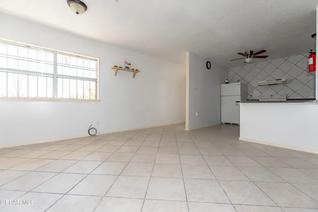 a view of a livingroom with an empty space and a window