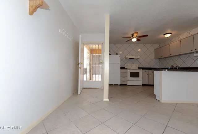 wooden floor in an empty room with a kitchen