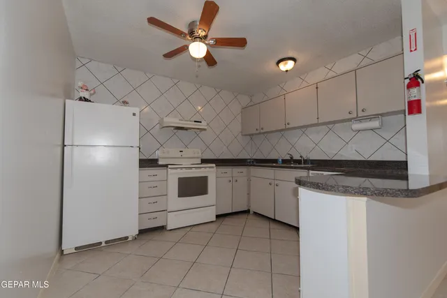 a kitchen with cabinets and stainless steel appliances