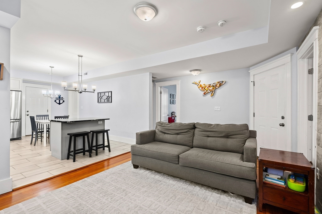 51 New Ocean Street, Unit 2 Swampscott, MA 01907 - Photo 5 of 20 a living room with furniture and a dining table