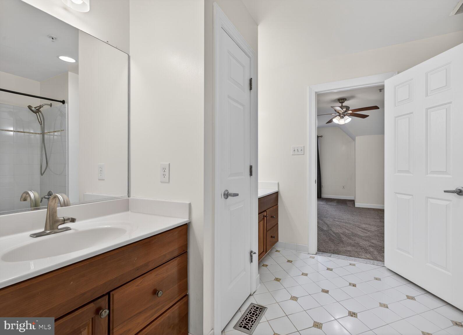 593 Cedar Spring Street Gaithersburg, MD 20877 - Photo 12 of 28 a bathroom with a sink a toilet a mirror and shower