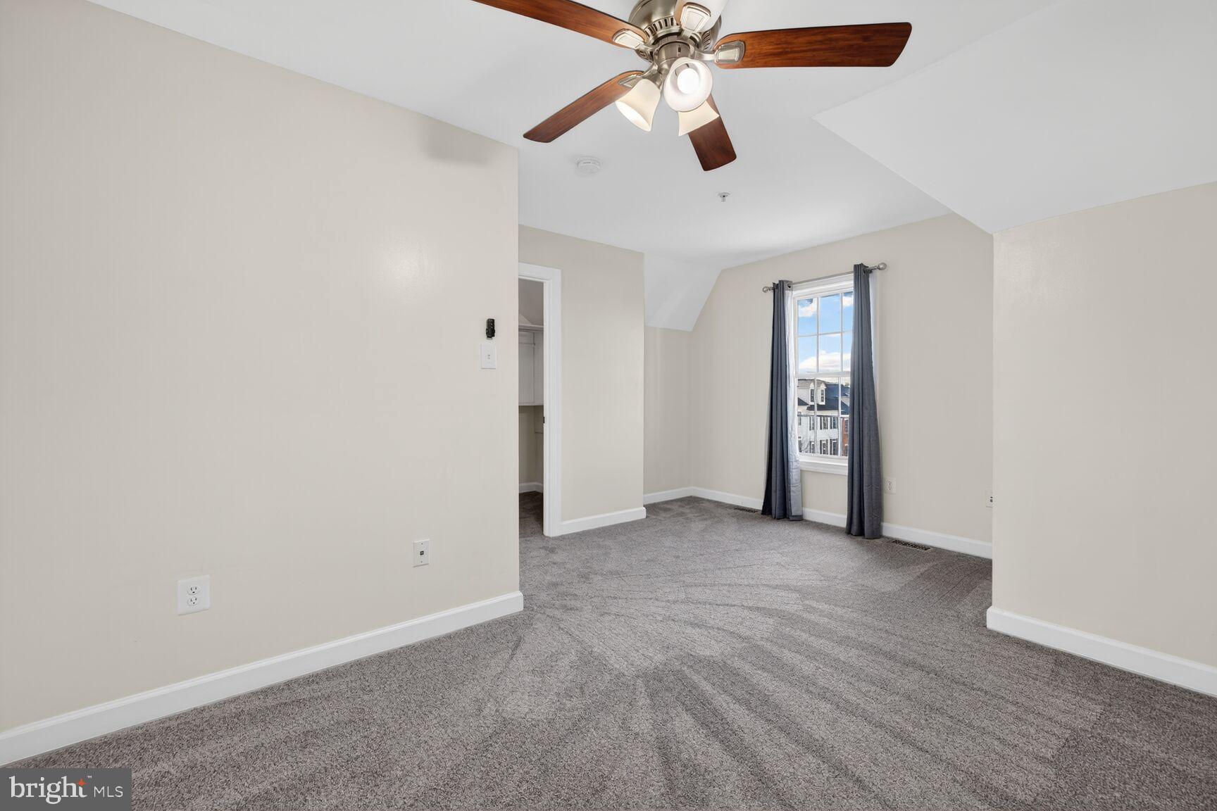 593 Cedar Spring Street Gaithersburg, MD 20877 - Photo 15 of 28 an empty room with closet and a ceiling fan