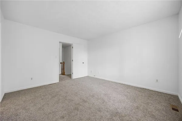 a view of an empty room and entryway