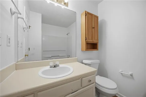 a bathroom with a sink a toilet and a mirror