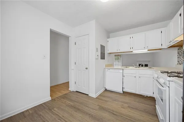 a view of a kitchen with wooden floor