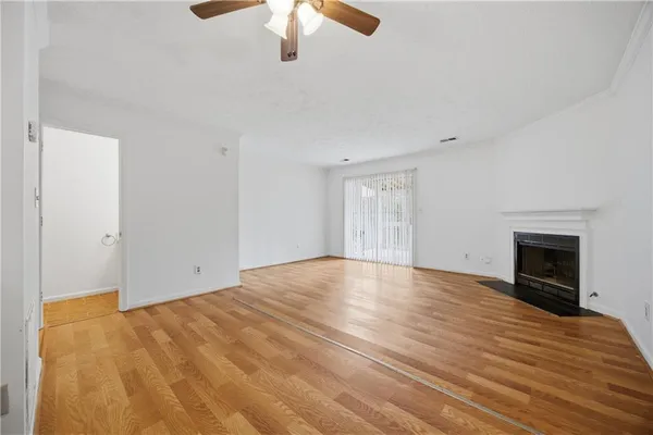 wooden floor in an empty room with a fireplace
