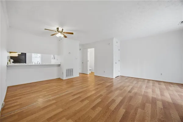 a view of an empty room with a kitchen