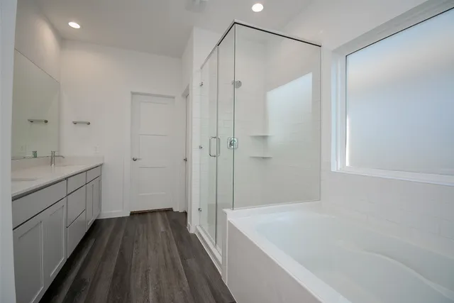 a white bath tub sitting next to a white sink