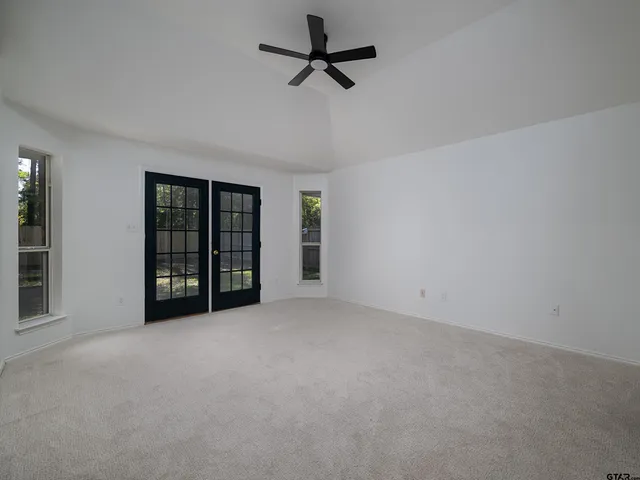 an empty room with closet and entryway