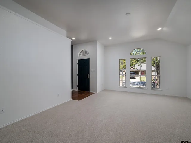 an empty room with windows and open view