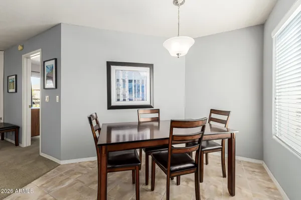 a view of a dining room with furniture and window