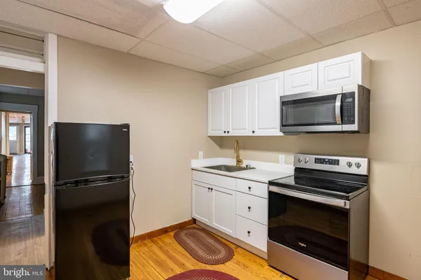 a kitchen with a sink stove and microwave