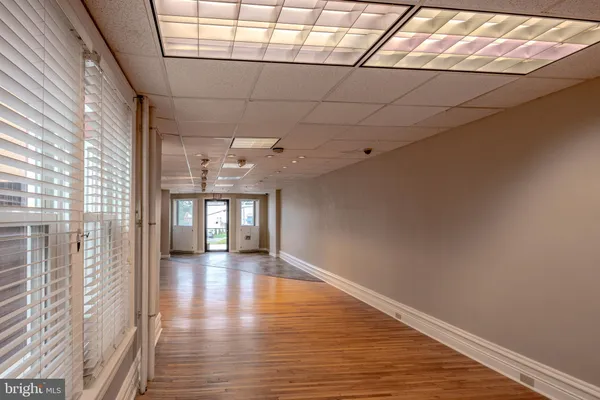 a view of a hallway with wooden floor