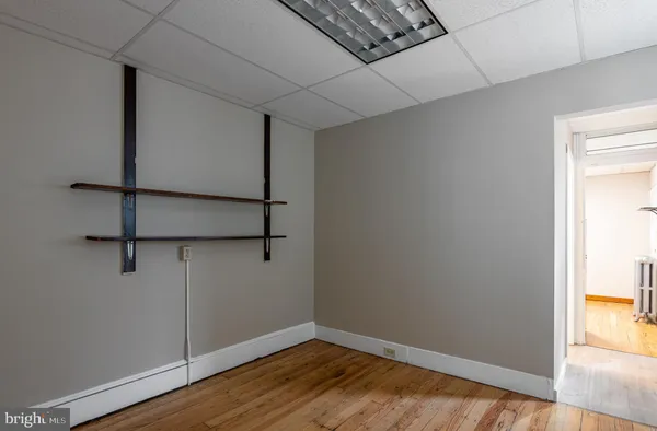 a view of a room with wooden floor